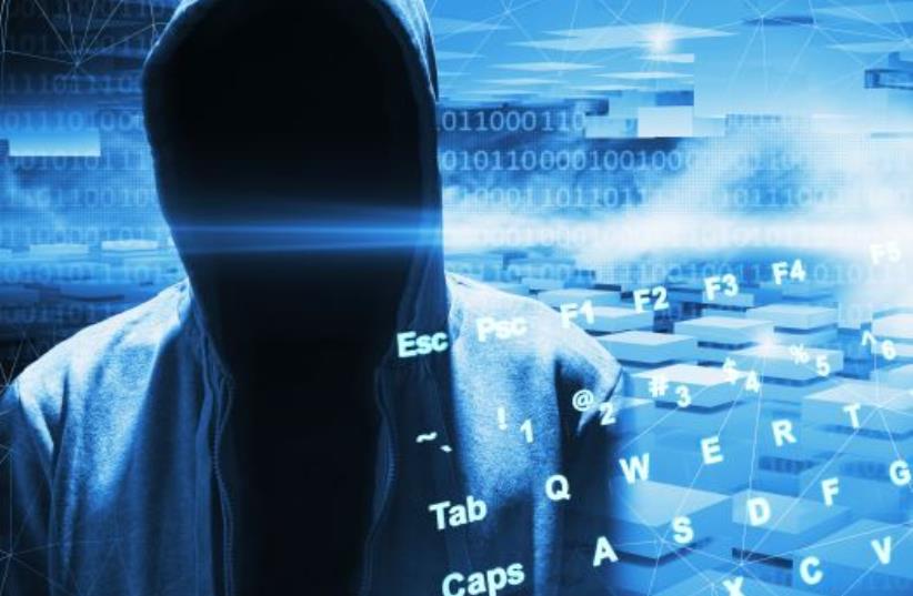 Hacker in a hood (photo credit: INGIMAGE)