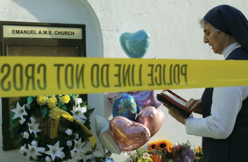 Sister Mary Thecla, from the Daughters of St. Paul, prays outside the Emanuel African Methodist Episcopal Church in Charleston, South Carolina. (photo credit: REUTERS)