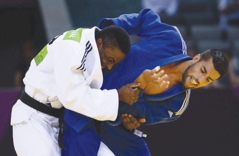 Israeli judoka Golan Pollack competing against Loic Korval of France (photo credit: OLYMPIC COMMITTEE OF ISRAEL)