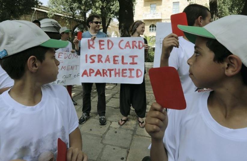 PALESTINIAN KIDS protest in favor of ejecting Israel from FIFA, the soccer federation (photo credit: REUTERS)