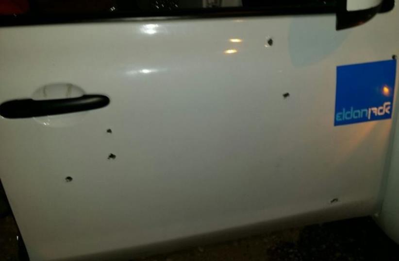 Vehicle with bullet hole punctures on the scene of a shooting attack in the West Bank, June 29, 2015 (photo credit: TAZPIT)