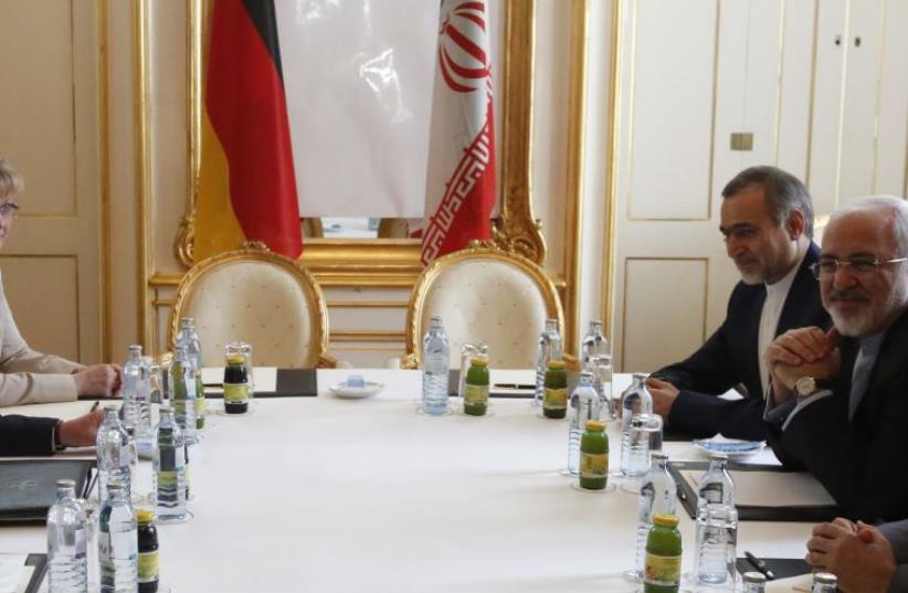  Iranian FM Javad Zarif (R) waits for the start of a bilateral meeting with Germany in Palais Coburg, the venue for nuclear talks in Vienna, Austria, July 2, 2015. (photo credit: REUTERS)