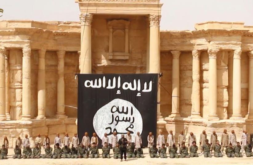 ISIS executes Syrian soldiers in ruins of ampitheater in Palmyra (photo credit: WELAYAT HOMS / AFP)