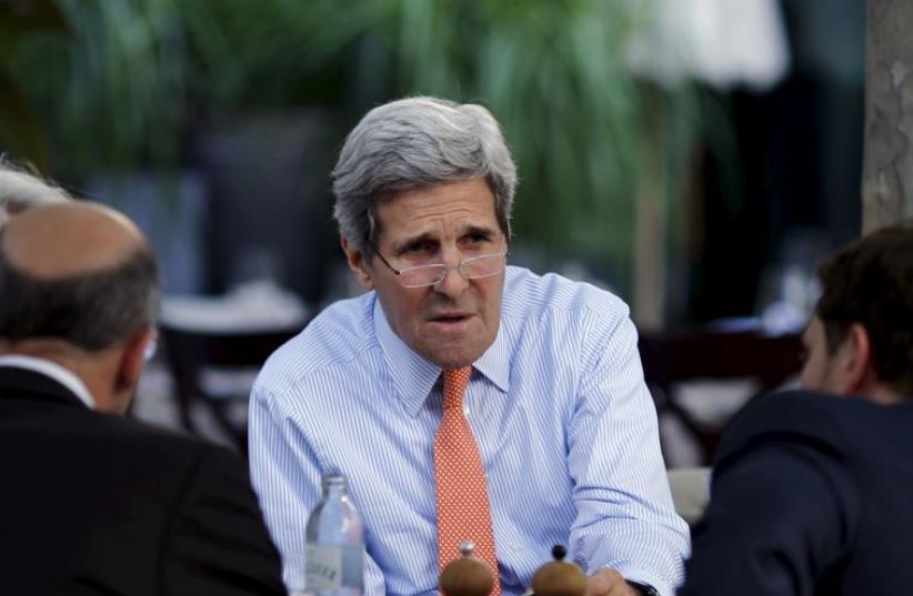 US Secretary of State John Kerry meets with US delegation to Iran talks on the terrace of a hotel where the negotiations are being held in Vienna, Austria July 2, 2015. (photo credit: REUTERS)