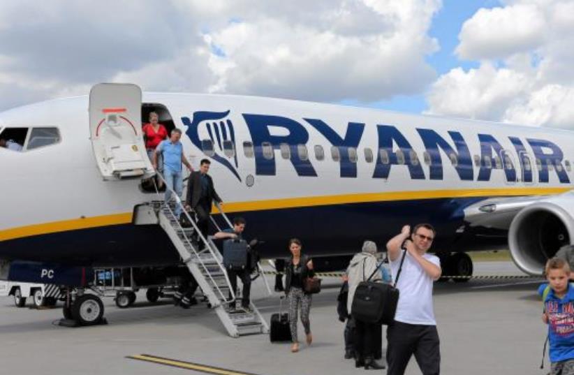 File photo of passangers leaving a Ryanair aircraft at Modlin airport near Warsaw, Poland June 26, 2014.  (photo credit: REUTERS)