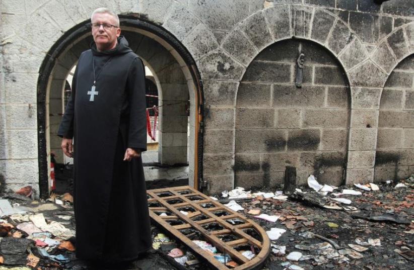 Abbot Gregory Collins, head of the Order of St. Benedict in Israel, stands amid the damage. (photo credit: Courtesy)