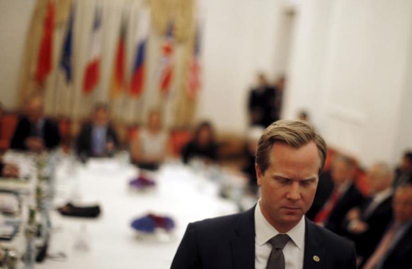 A member of the US delegation asks reporters to leave a room where foreign ministers from the  P5+1 and EU meet during the Iran talks in Vienna, July 7, 2015.  (photo credit: REUTERS)