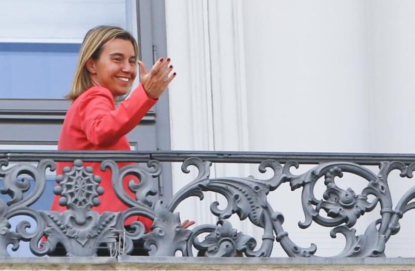 European Union foreign policy chief Federica Mogherini gestures as she stands on the balcony of Palais Coburg, the venue for nuclear talks in Vienna, Austria, July 13, 2015. (photo credit: REUTERS)
