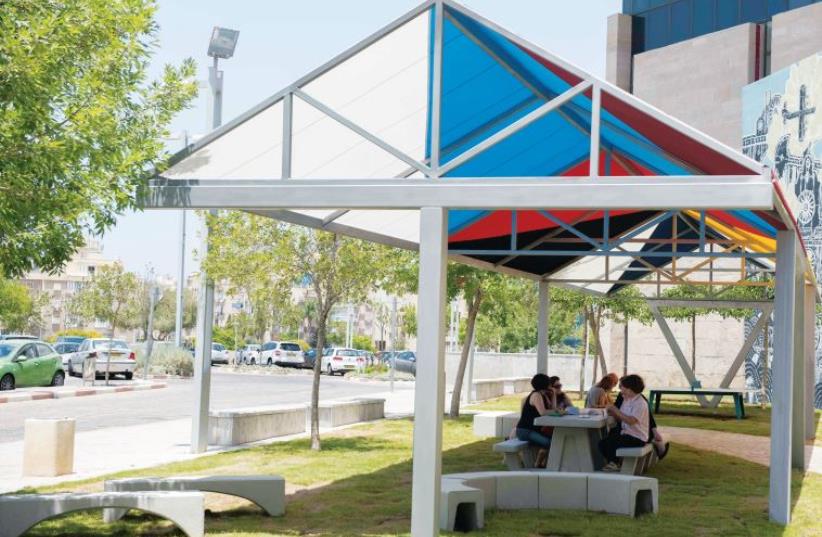 Outdoor shade installation, with cooling cover provided by a new form of acrylic fiber. (photo credit: DESIGN MUSEUM HOLON)