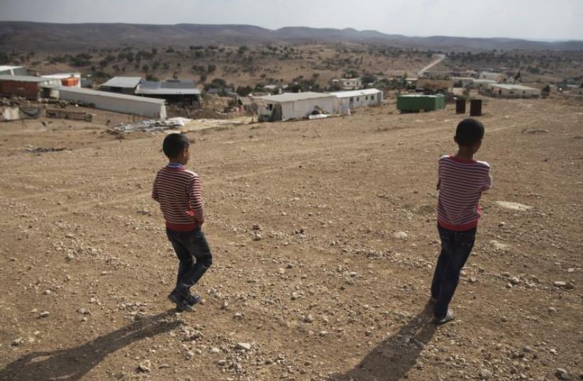 Bedouin boys walk towards a village in southern Israel's Negev desert (photo credit: REUTERS)
