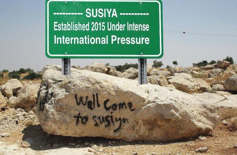 WILL THIS be the new sign greeting visitors to Susiya? The authors argues the Palestinian narrative is based on false information.  (photo credit: Courtesy)