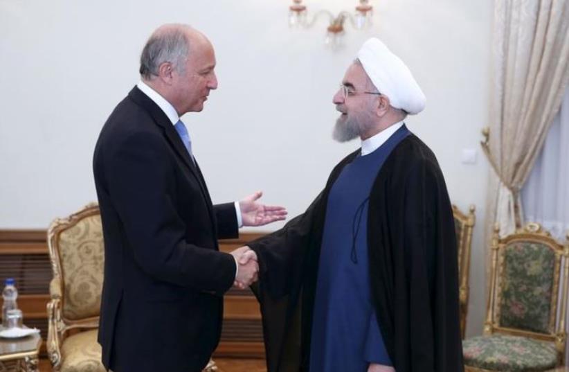 Iran's President Hassan Rouhani (R) welcomes French foreign minister Laurent Fabius in Tehran July 29, 2015.  (photo credit: REUTERS)