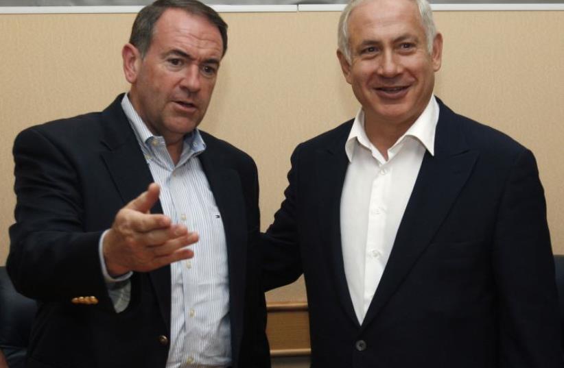 Former Arkansas Governor Mike Huckabee (L) meets Prime Minister Benjamin Netanyahu in Tel Aviv (photo credit: REUTERS)