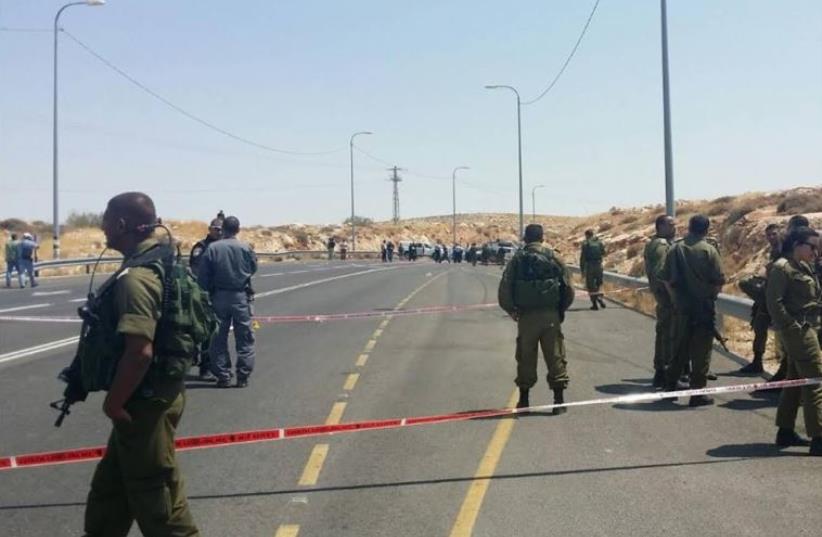 The closed-off road after an Israeli driver was fired at by a Palestinian driver near Kochav Hashahar (photo credit: TAZPIT)
