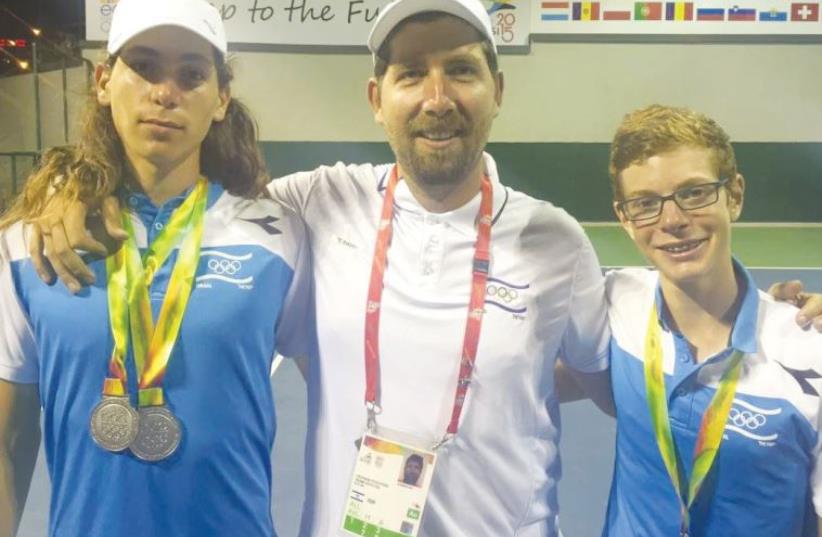 Yshai Oliel (left) and Roi Ginat (right) pose for a photo with coach Jan Pochter (center) (photo credit: COURTESY OLYMPIC COMMITTEE OF ISRAEL)