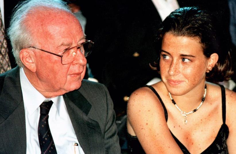 Noa Ben Artzi Rothman looks towards her grandfather, then-prime minister Yitzhak Rabin, as they sit in the audience of an international fashion show in March 1995 (photo credit: REUTERS)