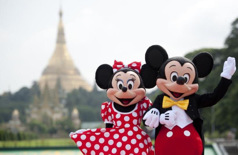 Walt Disney characters Mickey Mouse (R) and Minnie Mouse. (photo credit: YE AUNG THU / AFP)
