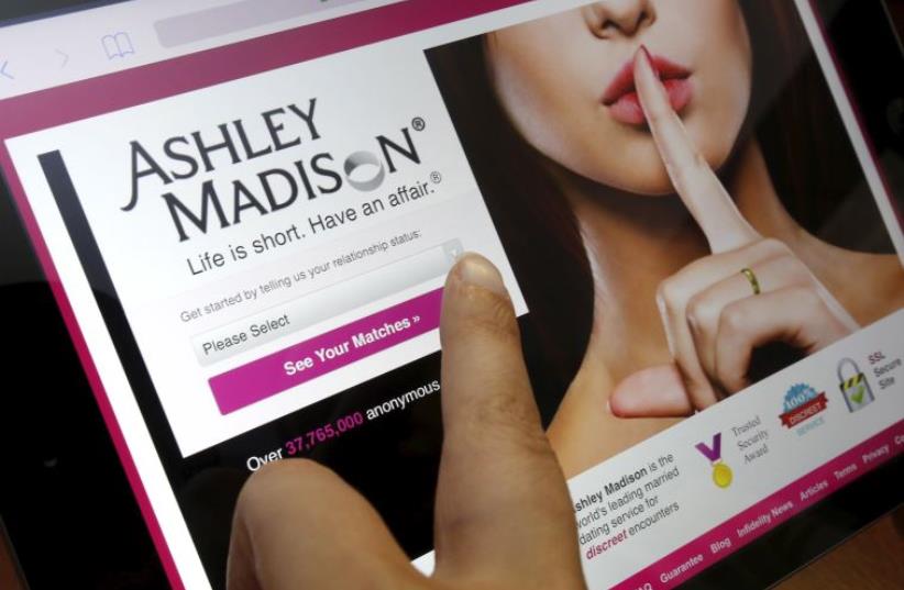 The homepage of the Ashley Madison website is displayed on an iPad, in this photo illustration (photo credit: REUTERS)