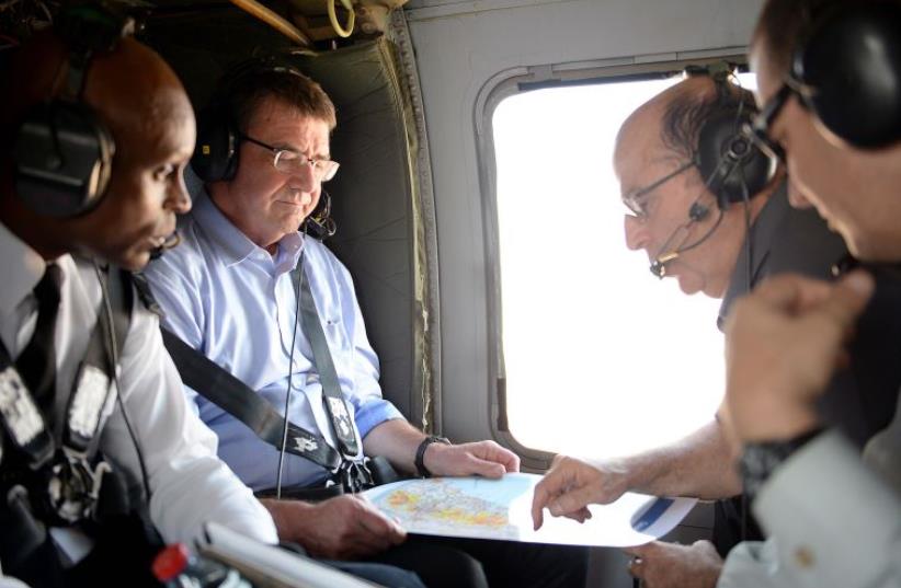 US Secretary of Defense Ash Carter (second from left) and Defense Minister Moshe Ya'alon look over the planned route of their visit to the Israel-Lebanon border (photo credit: US DEPARTMENT OF DEFENSE)