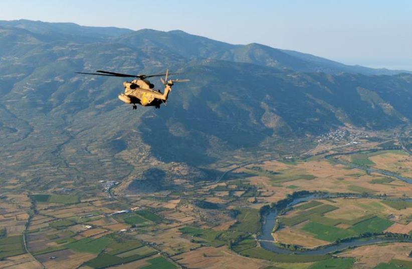 Israeli Apache helicopter flies over Greece's mountainous countryside during a joint-training exericise with the Greek military (photo credit: IDF)