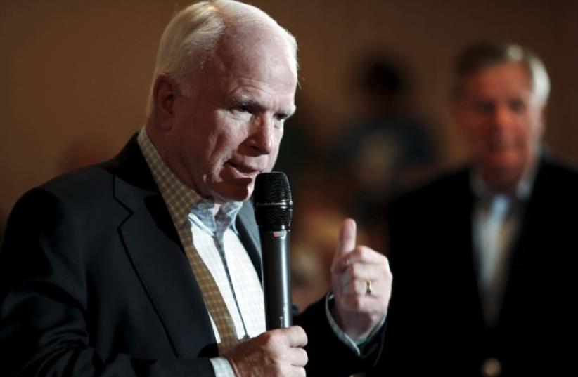 Arizona Senator and 2008 Republican presidential nominee John McCain speaks at a campaign town hall event for South Carolina Senator and U.S. Republican presidential candidate Lindsey Graham in Manchester, New Hampshire (photo credit: REUTERS)