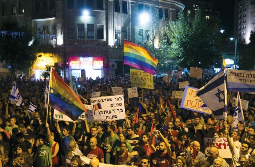 Protesters gather in Jerusalem on Saturday night after the Gay Pride Parade stabbings. (photo credit: REUTERS)