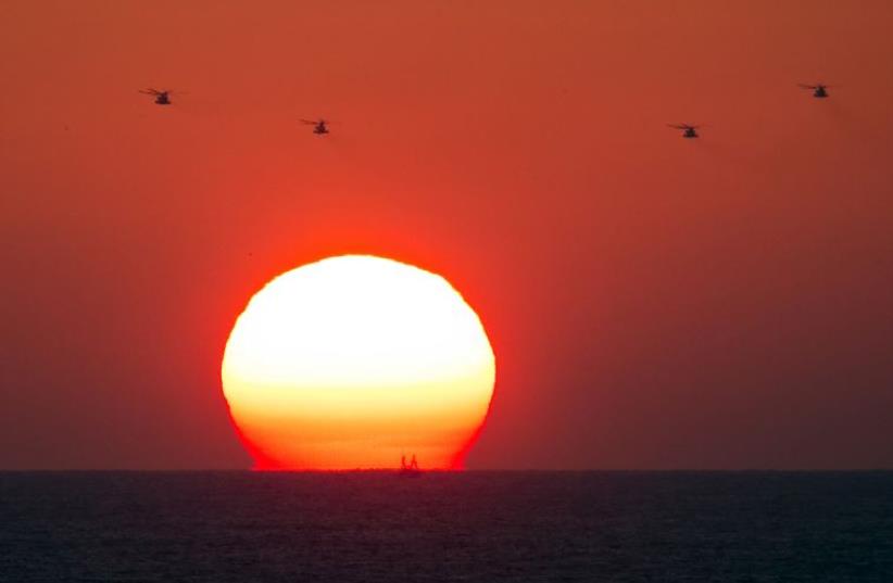 Four military helicopters fly over the Mediterranean sea opposite the port of Ashdod (photo credit: REUTERS)