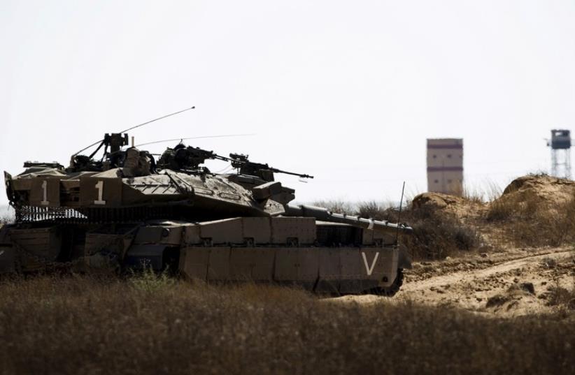 An IDF tank takes position along Israel's border with Egypt's North Sinai (photo credit: REUTERS)