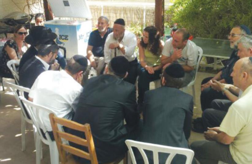 ULTRA-ORTHODOX activists visit the Jerusalem home of the parents of Shira Banki, who was murdered at the Jerusalem Gay Pride Parade two weeks ago, on Friday. (photo credit: GESHER)
