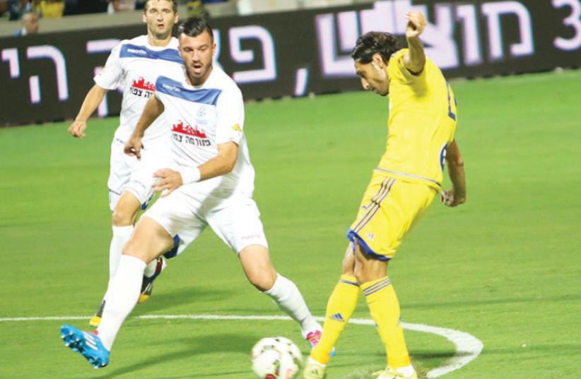 Maccabi Tel  Aviv  striker  Barak  Badash (right) was given a chance in the yellow-and-blue’s starting  lineup last night, but he failed to find the back of the net in the 3-0 Toto  c up defeat to Maccabi  Petah Tikva at  Bloomfield Stadium.  (photo credit: ADI AVISHAI)
