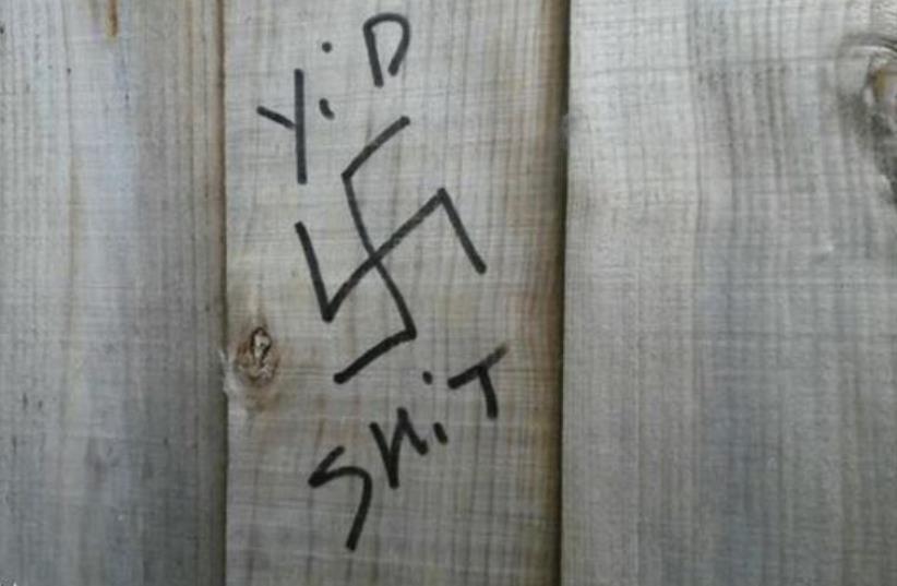 Anti-Semitic graffiti on gate of Jewish school in UK. (photo credit: SHOMRIM)