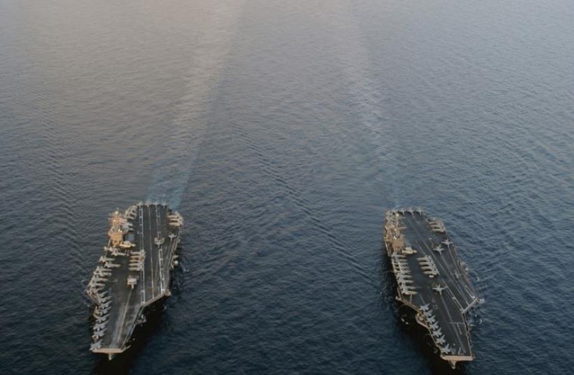 THE NIMITZ-CLASS aircraft carriers USS Abraham Lincoln and USS John C. Stennis plod their way through the Persian Gulf in 2012. ‘Obama’s aversion to launching a preemptive attack on Iran’s nuclear sites is the result of America’s bitter experiences in Afghanistan and Iraq and Obama’s herculean effor (photo credit: REUTERS)