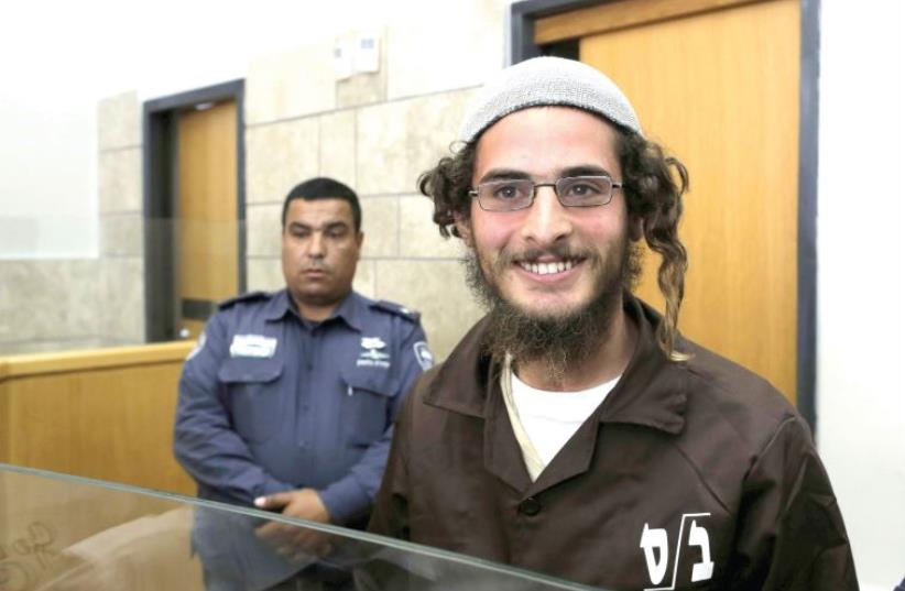 Meir Ettinger attends a remand hearing at the Magistrate’s Court in Nazareth. (photo credit: AMMAR AWAD / REUTERS)