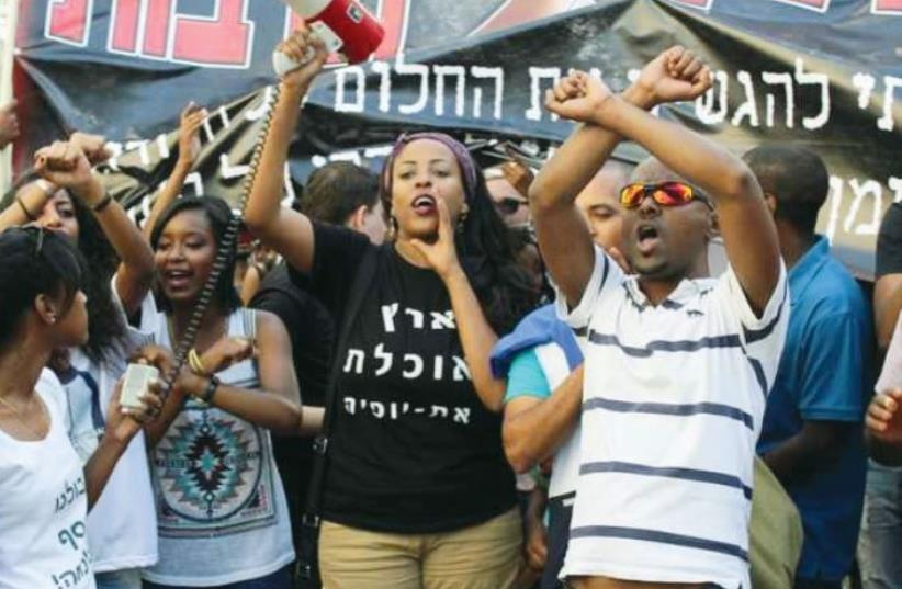 Demonstrators in Tel Aviv gather to protest racism and police brutality (photo credit: BEN HARTMAN)