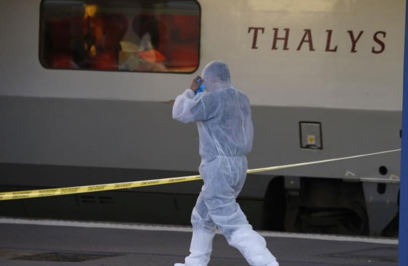 French investigating police in protective clothing prepare to enter Thalys high-speed train  (photo credit: REUTERS)