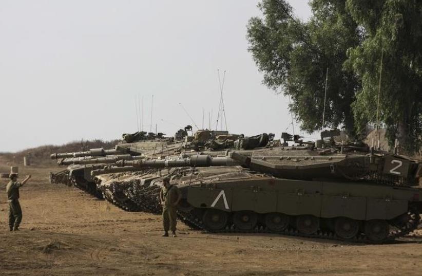  IDF tank exercise in the Golan Heights, near the cease-fire line between Israel and Syria  (photo credit: REUTERS)