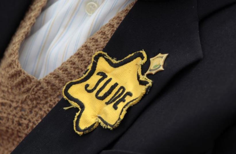 Polish born Mordechai Fox, an 89-year-old Holocaust survivor, wears a yellow Star of David on his jacket during a ceremony marking Holocaust Remembrance Day (photo credit: REUTERS)