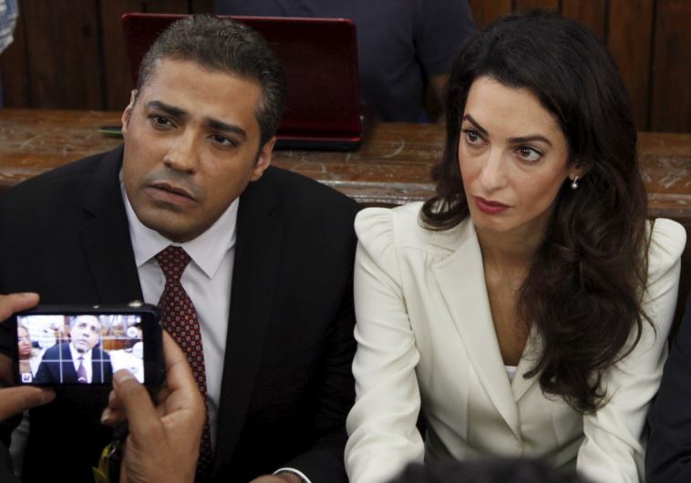Former al Jazeera bureau chief, Mohamed Fahmy, and his lawyer, Amal Clooney, await the verdict at a court in Cairo. (Reuters) 