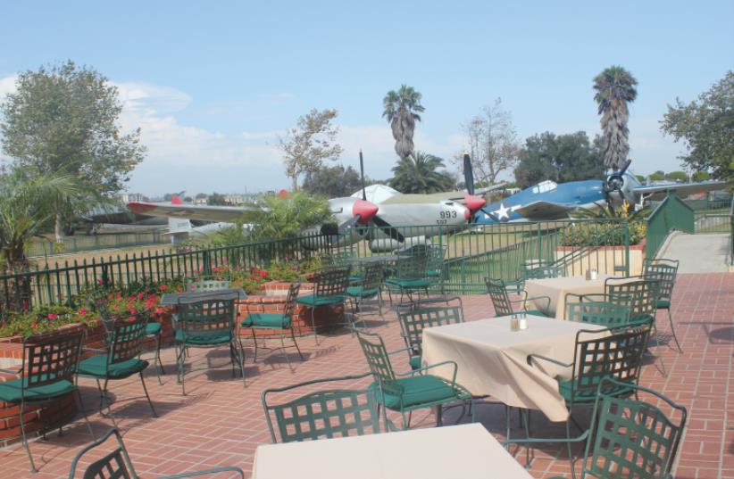 VISITORS CAN have a seat in the restaurant patio and have a close-up view of many of the old planes. (photo credit: GEORGE MEDOVOY)