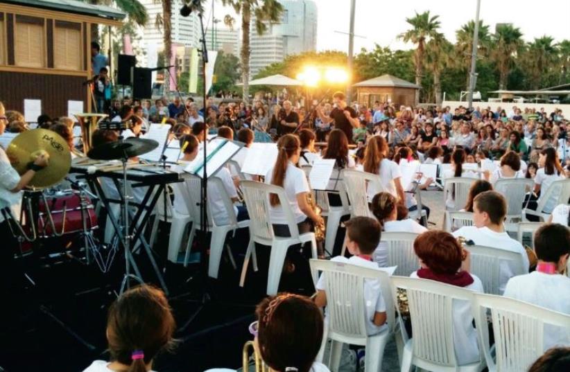 Buxbaum conducts the Tel Aviv Municipal Youth Wind Orchestra at Neveh Tzedek’s Old Train Station complex (photo credit: Courtesy)