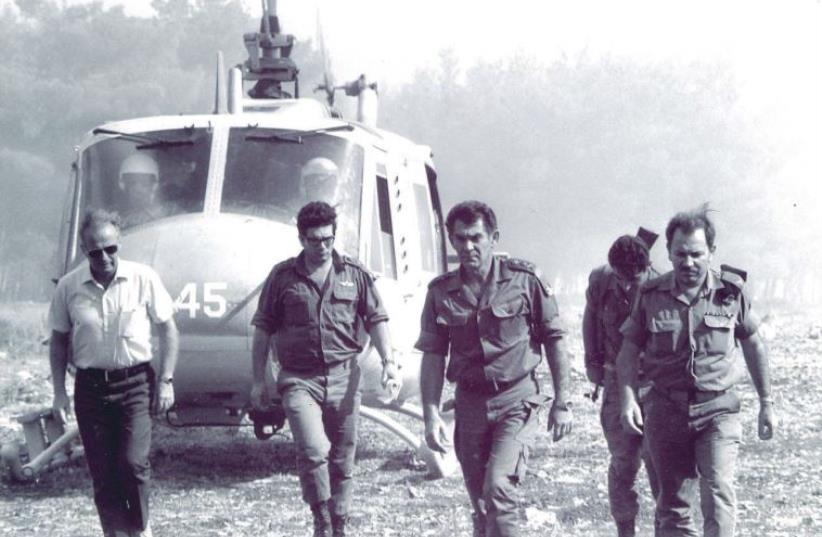 LT-Gen. David Elazar (center) alights from a helicopter to visit the troops on the Golan Heights. In the white shirt (left) is Yitzhak Rabin, serving as an informal advisor (photo credit: JERUSALEM POST ARCHIVE)
