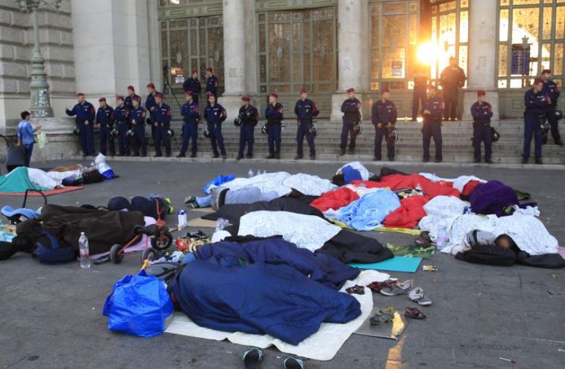Migrants sleep outside the Keleti railway station in Budapest (photo credit: REUTERS)