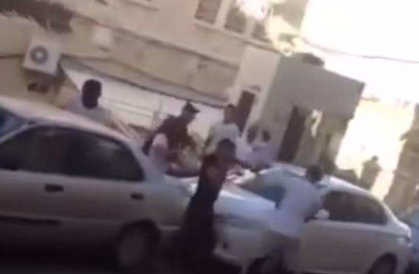 Settlers attacking a Palestinian in Hebron  (photo credit: screenshot)