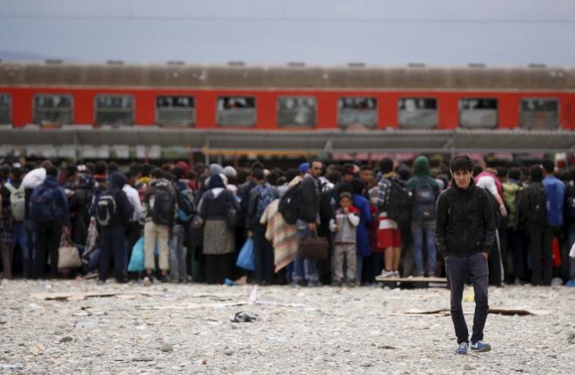 DATE IMPORTED: September 08, 2015 Migrants wait to board a train after crossing the Macedonian-Greek border near Gevgelija, Macedonia, September 8, 2015. (photo credit: REUTERS)
