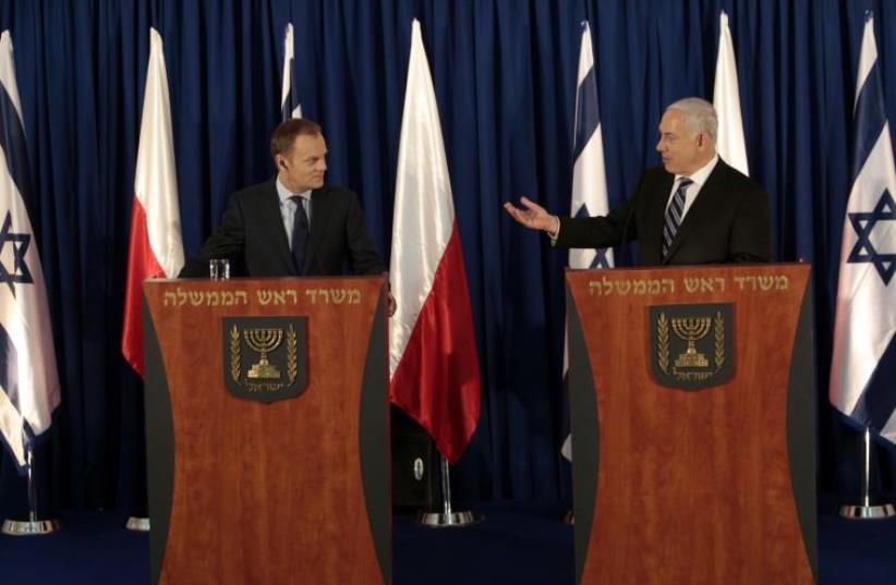 Israel's Prime Minster Benjamin Netanyahu (R) gestures during a news conference with his Polish counterpart Donald Tusk after a joint meeting of Polish and Israeli ministers in Jerusalem (photo credit: REUTERS/BAZ RATNER)