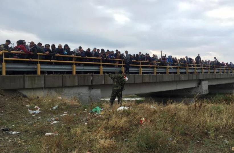 Migrants cross to Macedonia (photo credit: SETH J. FRANTZMAN)