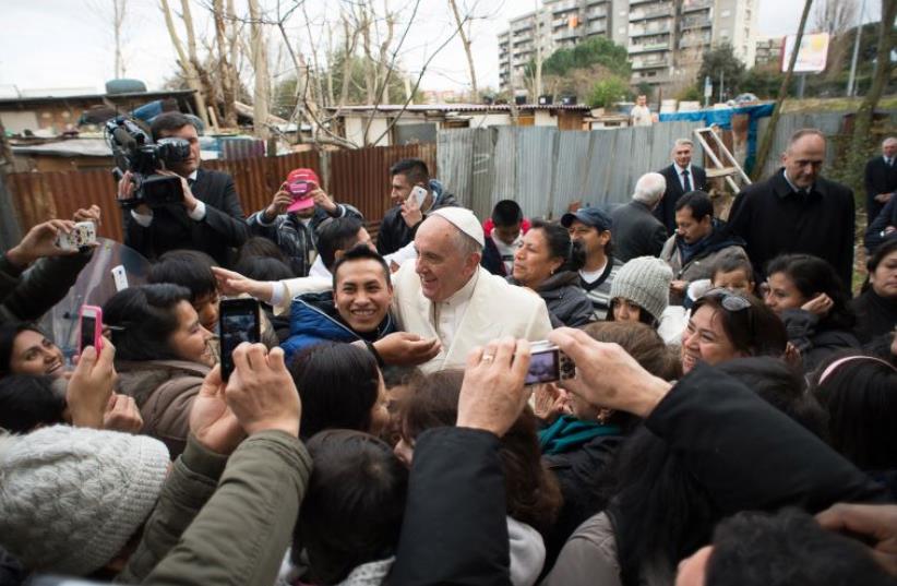 Pope Francis during a visit in a refugee camp on February 8, 2015 in Rome. (photo credit: OSSERVATORE ROMANO / AFP)
