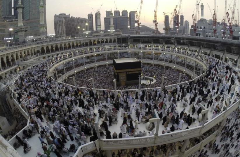 Muslim pilgrims pray around the holy Kaaba during their final circling at the Grand Mosque during the annual hajj pilgrimage (photo credit: REUTERS)