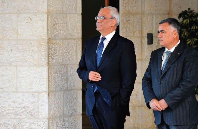 CHIEF PALESTINIAN negotiator Saeb Erakat (left) waits for for a foreign visitor at the Palestinian presidential offices in Ramallah last year (photo credit: REUTERS)