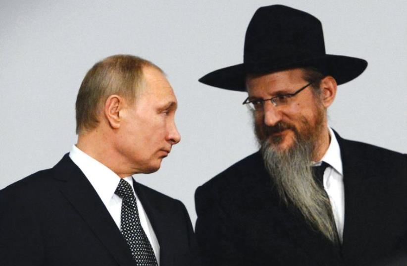 RUSSIAN PRESIDENT Vladimir Putin listens to Russian Chief Rabbi Berel Lazar earlier this year (photo credit: REUTERS)